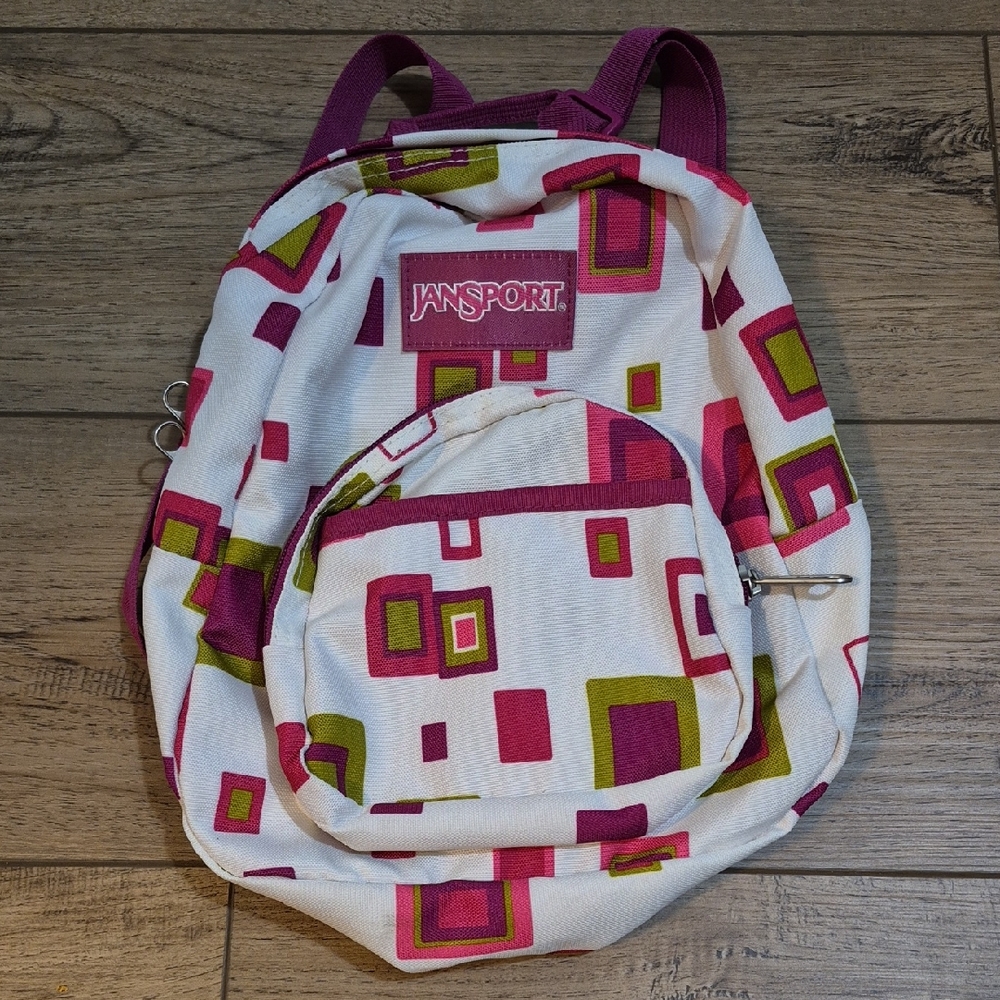 Jansport Mini Backpack with Pink and Green Geometric Pattern. 2 Pocket Front.